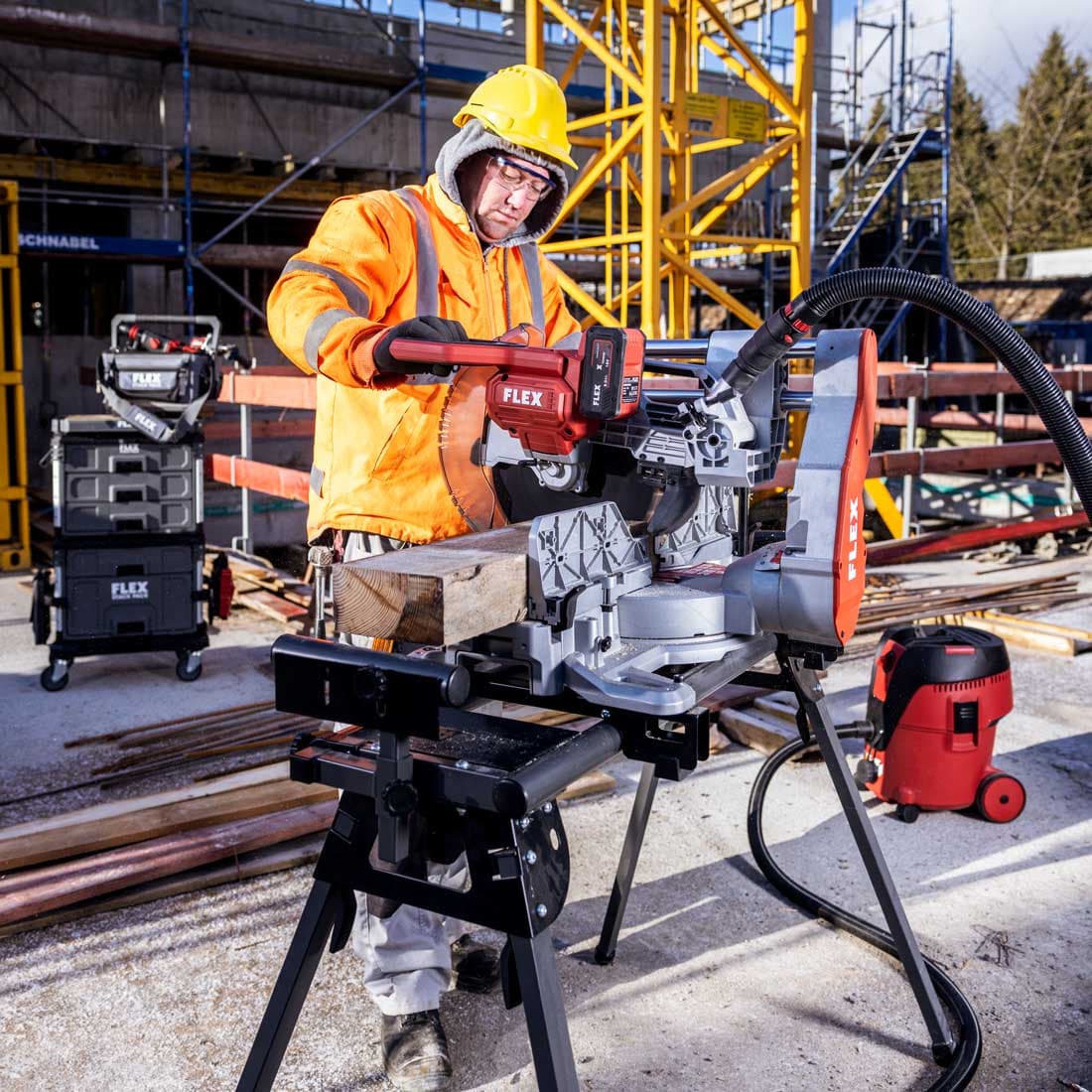 Construction worker cuts wooden beams with FLEX cordless mitre saw