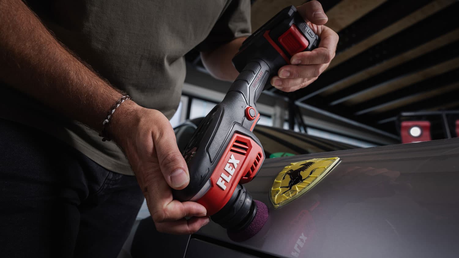 The FLEX PXCE 18-EC being used for targeted paint correction on a vehicle.
