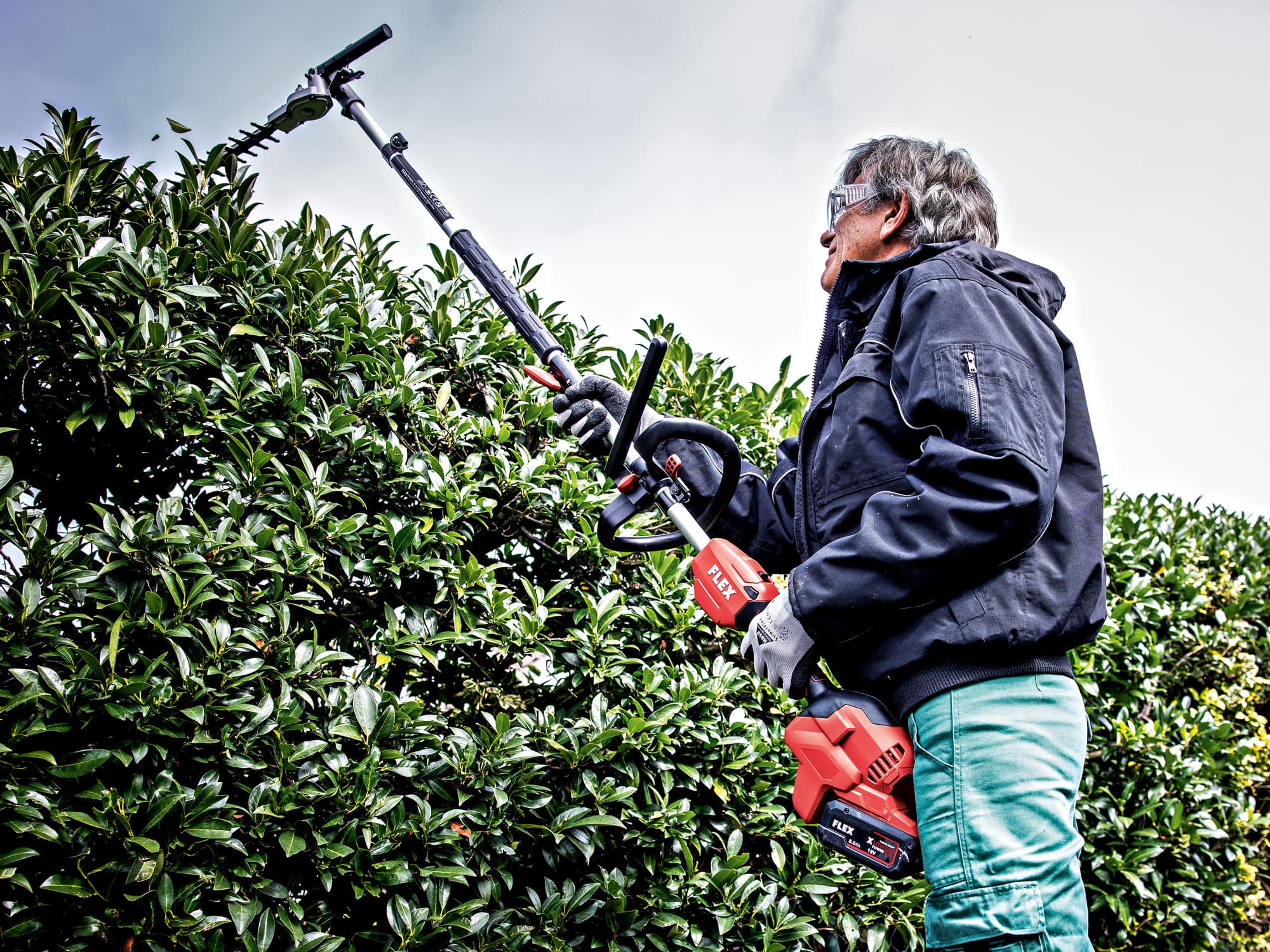 Hedge trimming with the FLEX cordless garden multi-tool and the GHT-A hedge trimmer attachment.