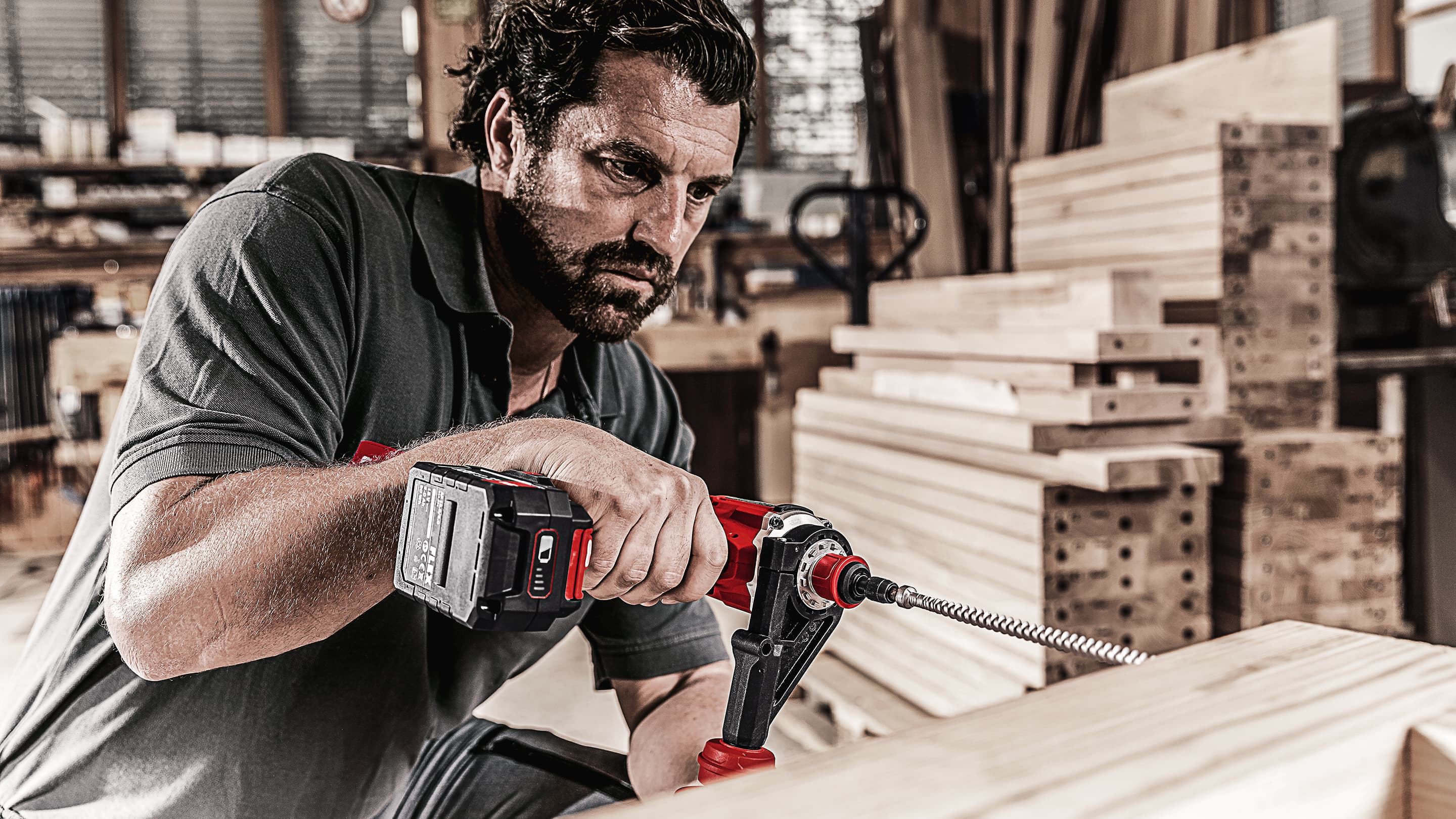 Screwing in wood screws with a cordless drill driver in the workshop